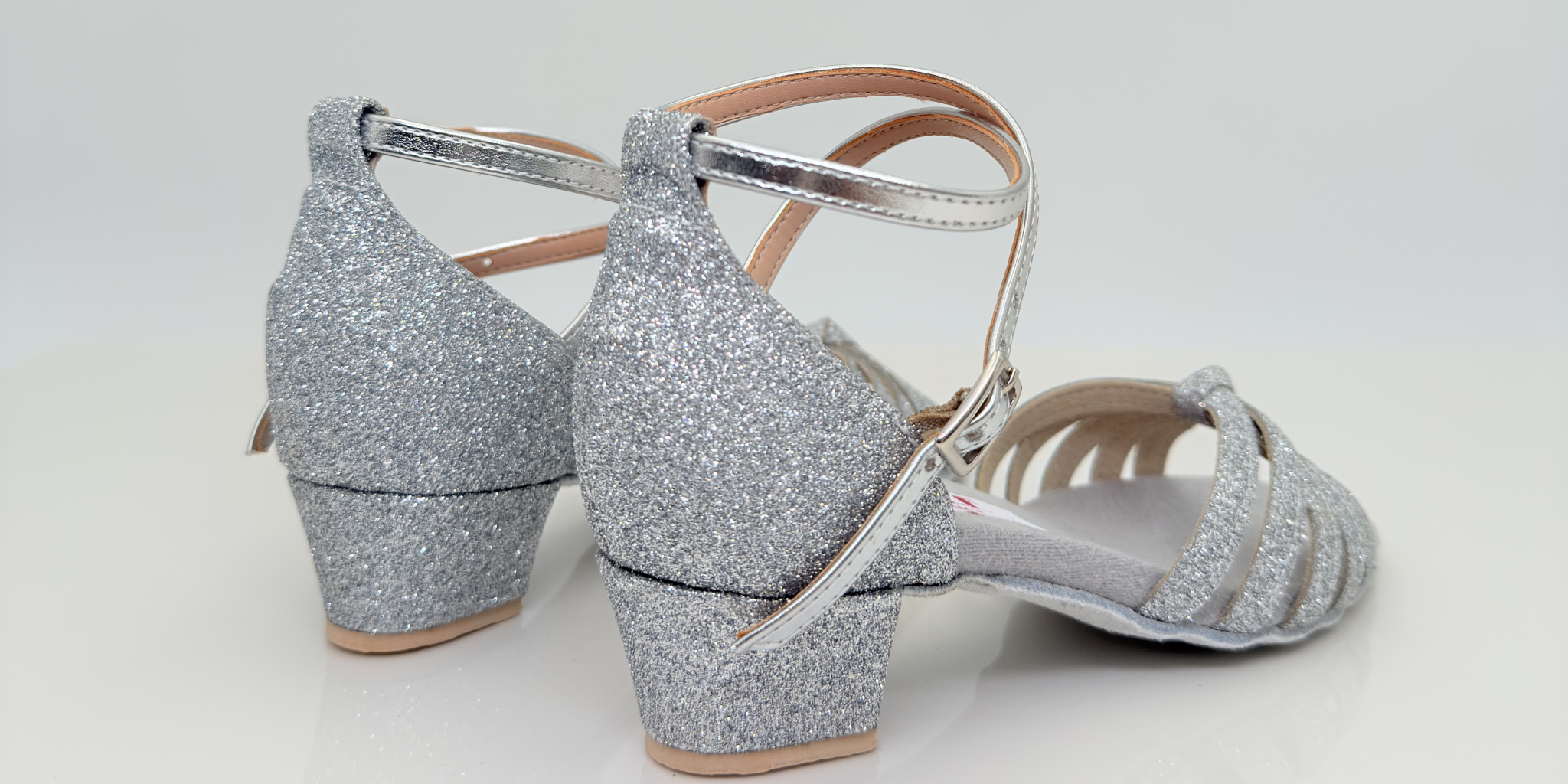 Sole art. 401G Nicole Rimini vista laterale, tessuto glitter argento brillante, cinturino incrociato caviglia 2CAI, tacco rocchetto 3,5 cm quadrato plateau 1cm, fascia a gabbia tomaia bambina, scarpe da ballo folk liscio romagnolo kids girl artigianali italiane
